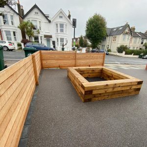 new wooden planter and fence on resin driveway