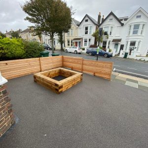 wooden planter in resin driveway