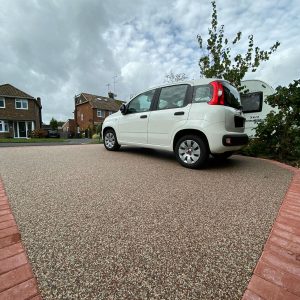 new resin driveway with car parked on it